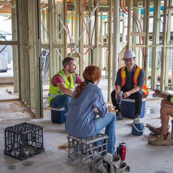 mixed gender construction workers at lunch