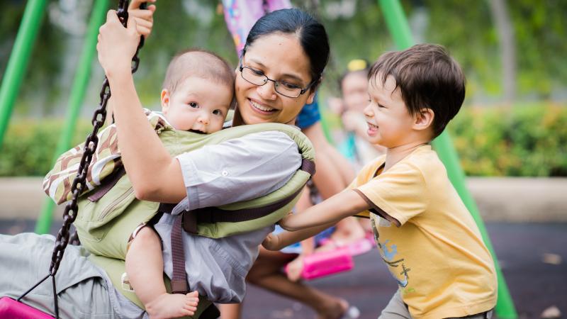 mother with kids on swings